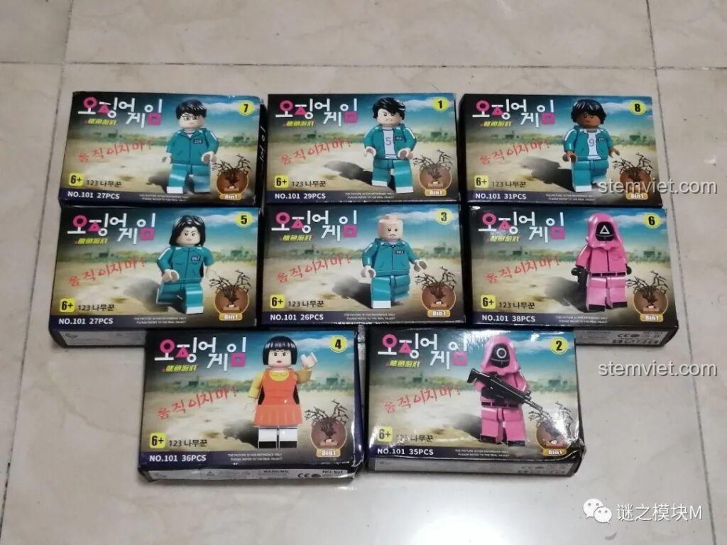 Toàn bộ hộp của bộ sưu tập minifigure Renzaima 101 Trò Chơi Con Mực, bao gồm các nhân vật chính và lính gác.