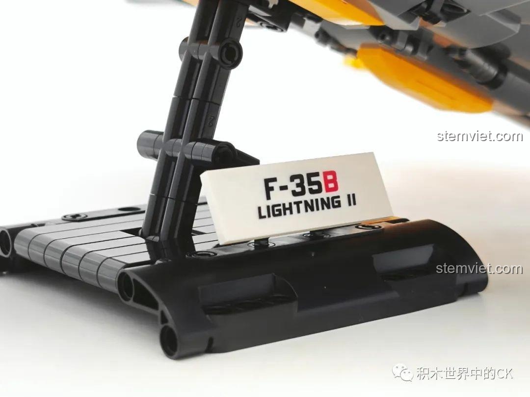 Góc nhìn từ dưới lên của đồ chơi mô hình Máy bay chiến đấu F-35B Lightning II, cho thấy chi tiết phần bụng và giá đỡ.