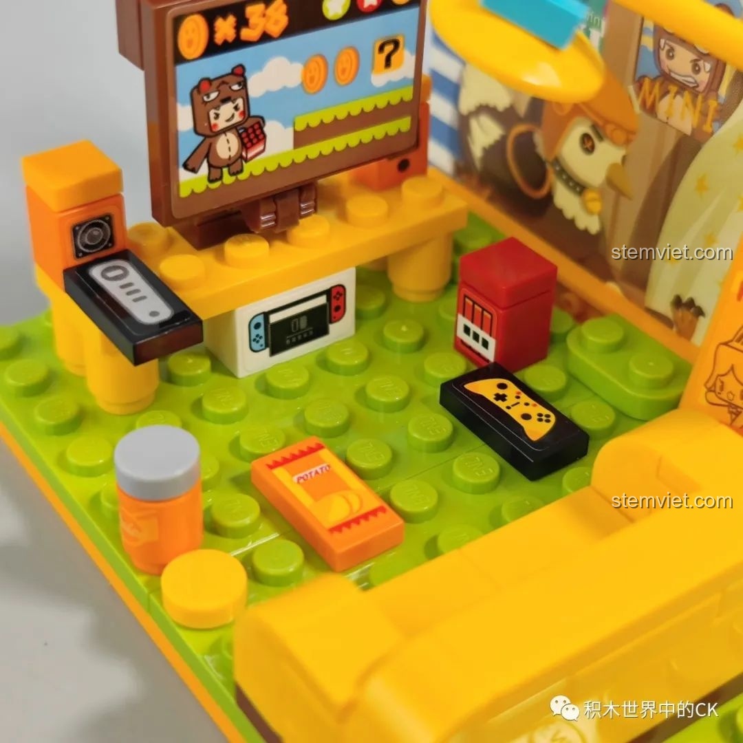 Chi tiết máy chơi game, tay cầm và đồ ăn vặt trong set đồ chơi Bear Boy.