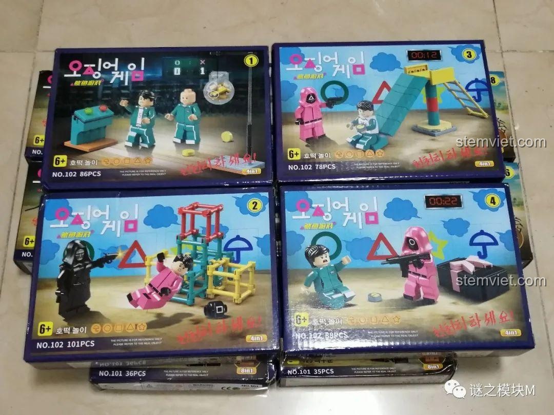 Các hộp của bộ Renzaima 102 với các cảnh game như cầu trượt, quan tài và các nhân vật phụ trong Trò Chơi Con Mực.