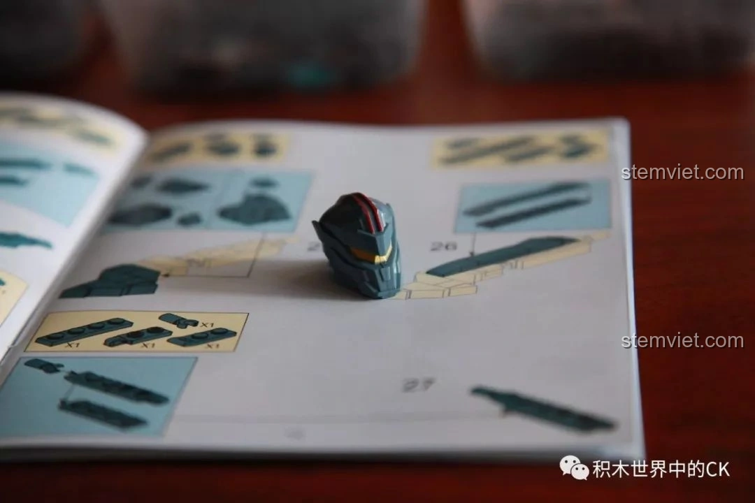 Chi tiết đầu của robot Gipsy Avenger từ bộ Sluban M38-B0726A, đặt trên sách hướng dẫn, cho thấy đường phân khuôn. Đánh giá Sluban M38 B0726A Người Máy Gipsy Avenger Phục Thù Lang Thang.