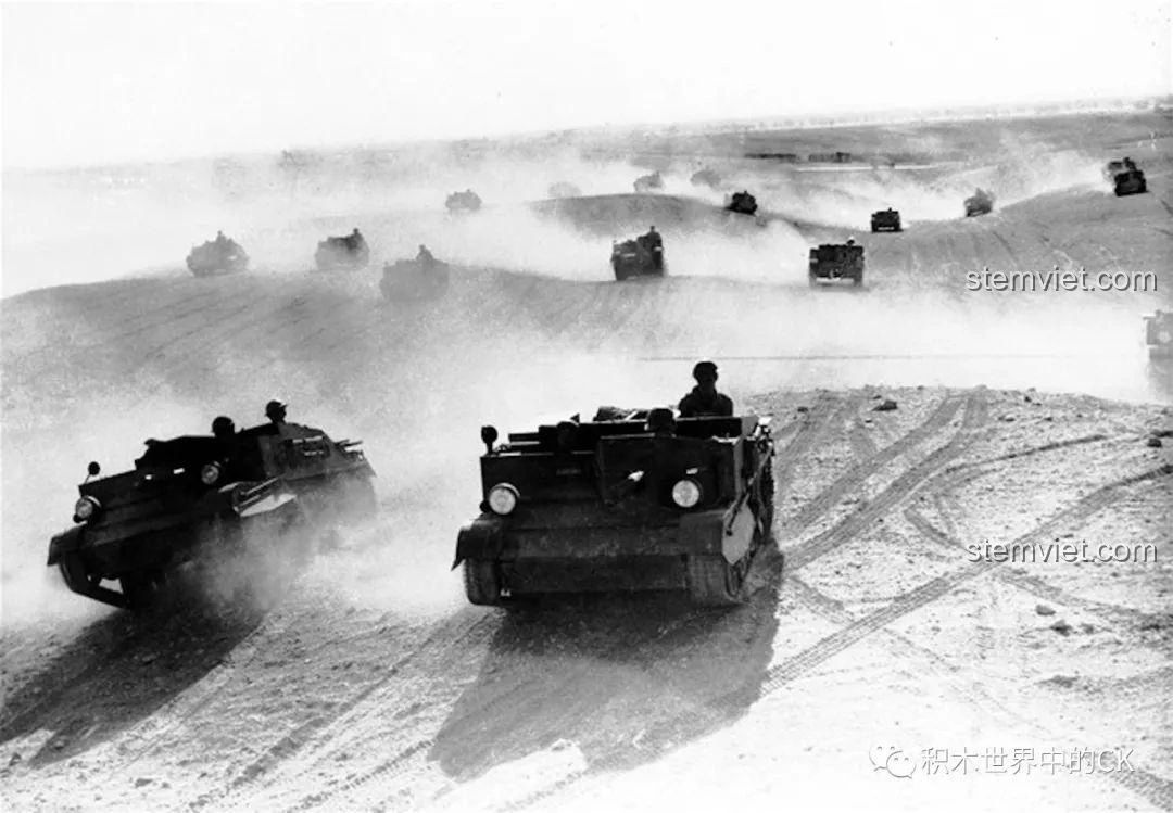 Đoàn xe vận tải Bren Carrier di chuyển trên chiến trường đầy bụi, thể hiện sự cơ động của quân đội Anh.