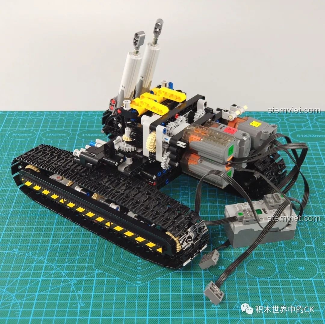 Giai đoạn lắp đặt động cơ và đi dây điện vào khung gầm của máy xúc Mould King 13112.