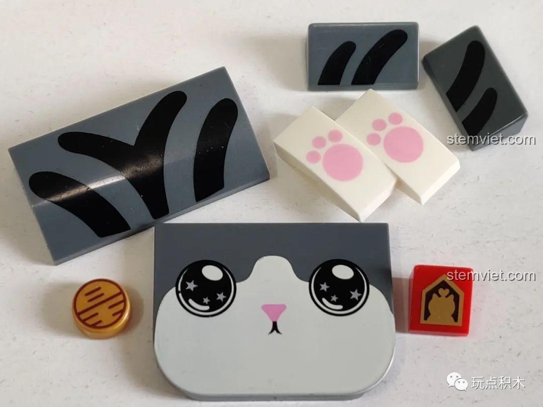 Các mảnh ghép in hình khuôn mặt, chân mèo và các chi tiết trang trí của mô hình GUDI 52051.