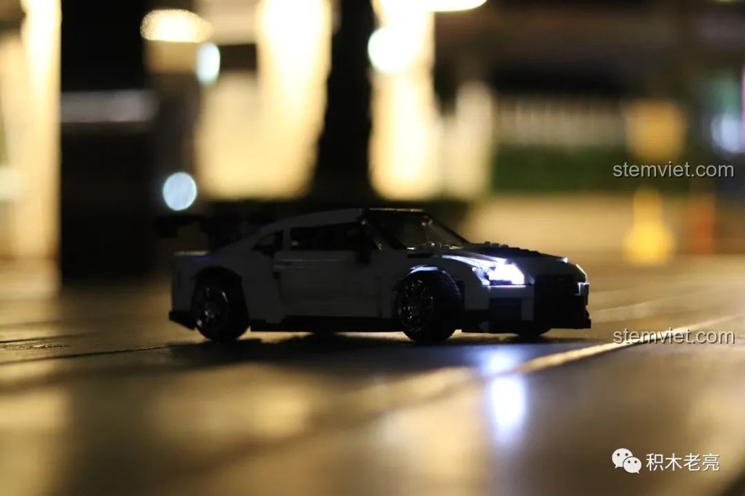 Mô hình xe đua Nissan GTR R35 lắp ráp Double Eagle 61020 trong đêm với đèn pha sáng rực, tạo hiệu ứng ấn tượng.