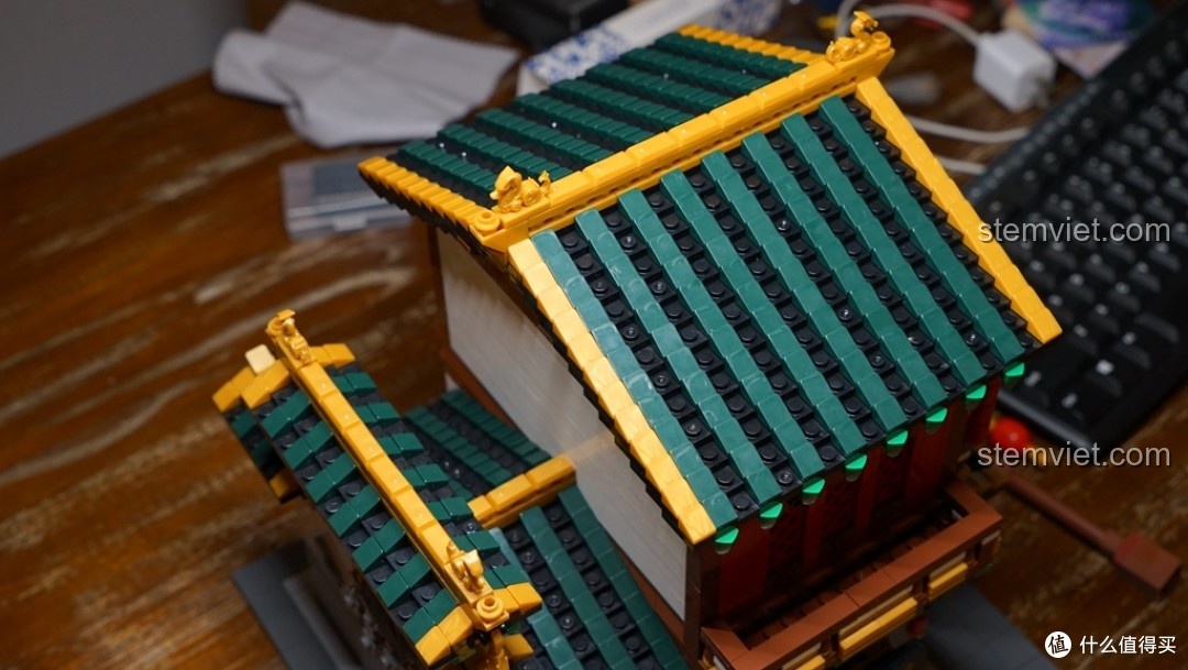 Nhận xét về chất lượng gạch vàng bóng trên mái nhà của bộ lắp ghép Tiệm Vải Lụa Phố Tàu Xingbao, một điểm chưa hoàn hảo.