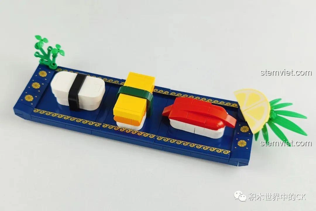 Các miếng sushi được đặt trên khay xanh trong bộ lắp ráp SEMBO 601414 Món Ăn Nhật Bản: Sushi, tạo cảm giác như một bữa ăn thực thụ.