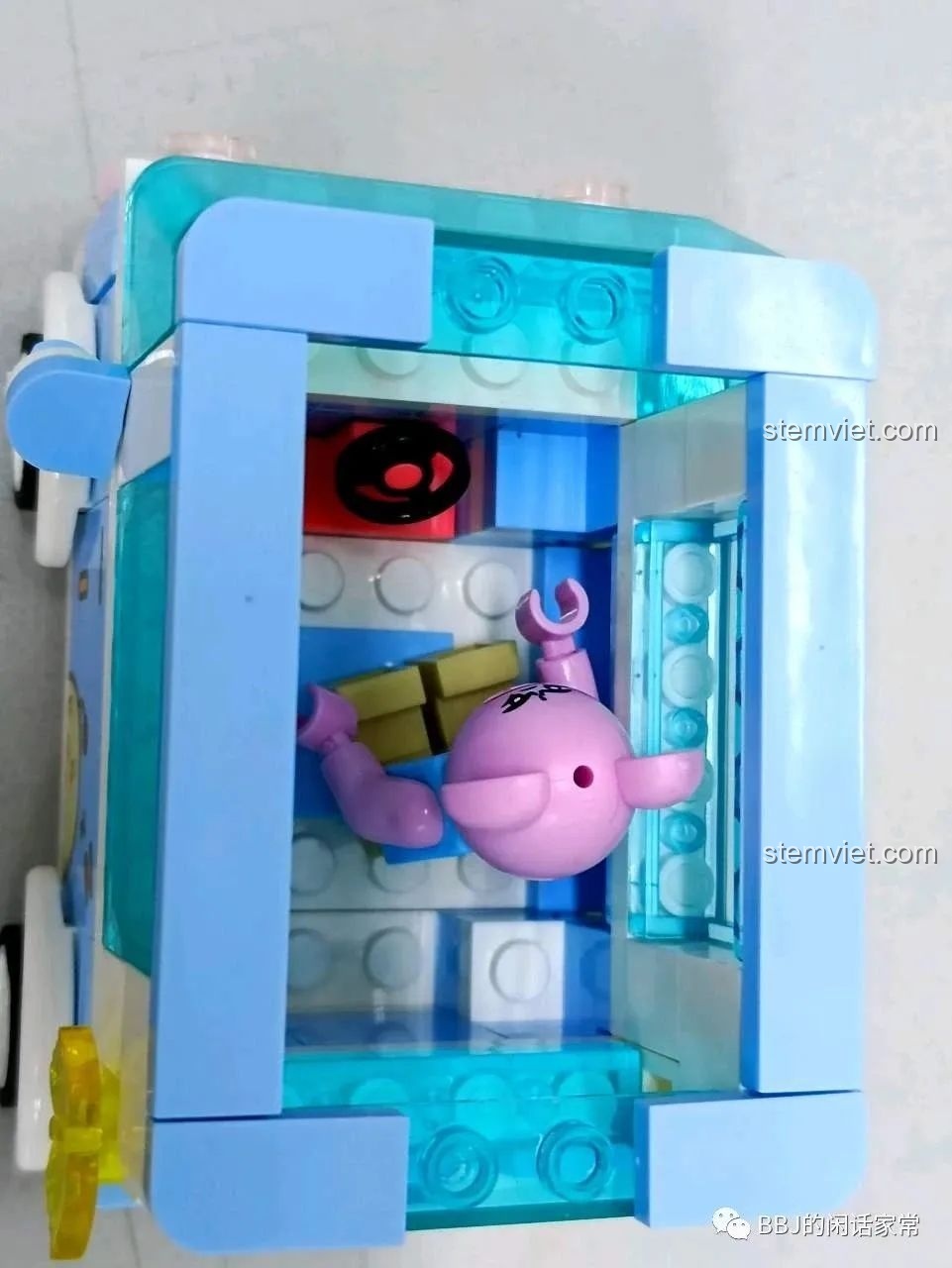 Một nhân vật hình chú heo màu hồng đang được đặt vào bên trong xe kem SEMBO 615004.