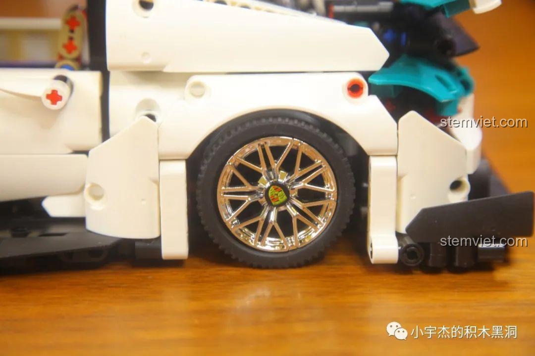 Cận cảnh bánh sau của xe KBOX 10214 với vành mạ chrome và logo Porsche.