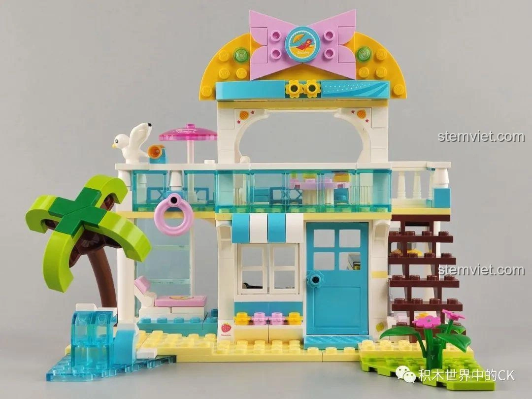 Mô hình biệt thự bãi biển QMAN 4804 hoàn thiện, với ô che nắng màu hồng trên ban công, tạo điểm nhấn.