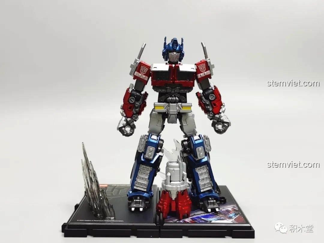 Mô hình Blokees 71147 Optimus Prime EX đứng trên đế trưng bày với hiệu ứng năng lượng, thể hiện tư thế sẵn sàng chiến đấu.