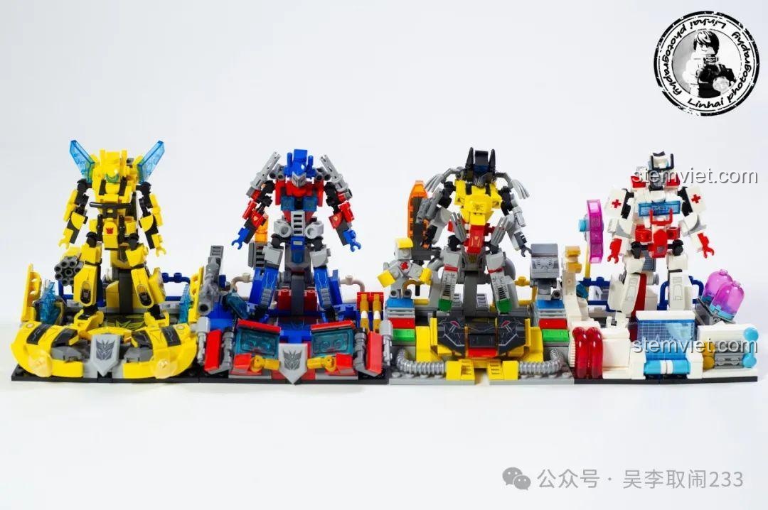 Bốn mô hình Robot Transformers và trạm chỉ huy xếp hàng ngang trên nền trắng.