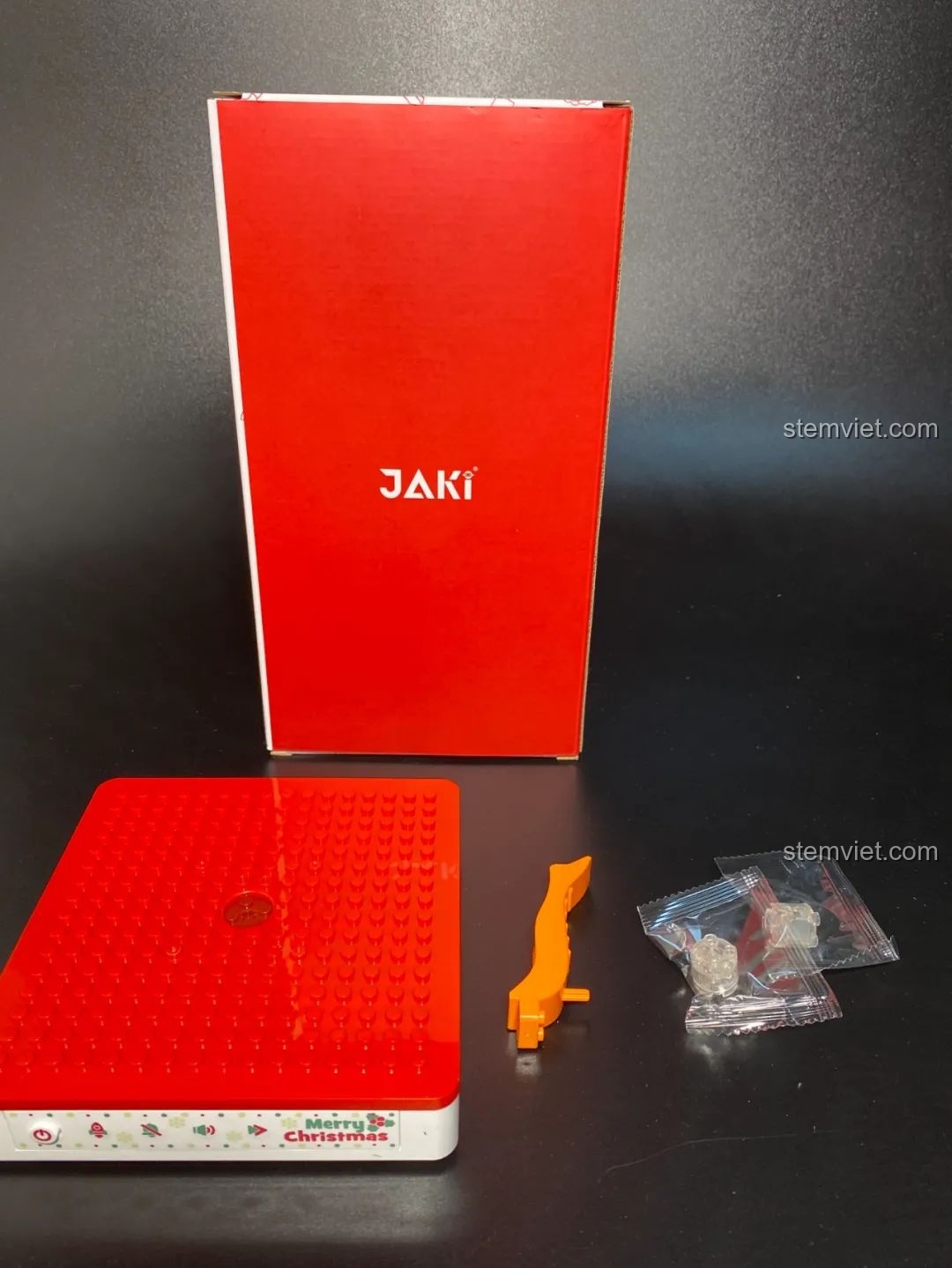 Đế nhạc thông minh và hai viên gạch phát sáng của Hộp nhạc Giáng Sinh Xoay Tự Động JAKI JK1365. Đồ chơi lắp ráp Giáng Sinh có nhạc.