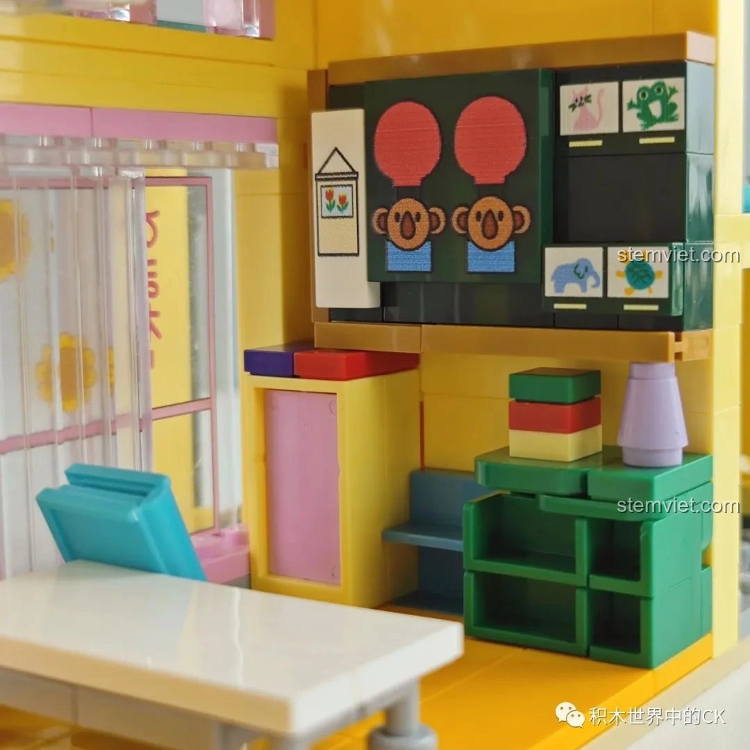 Chi tiết bàn học, quả bóng và cuốn sách trong bộ khối lắp ghép Nhà Trẻ Song Diệp Crayon Shin-chan cho bé trai 6+, tạo không gian học tập.