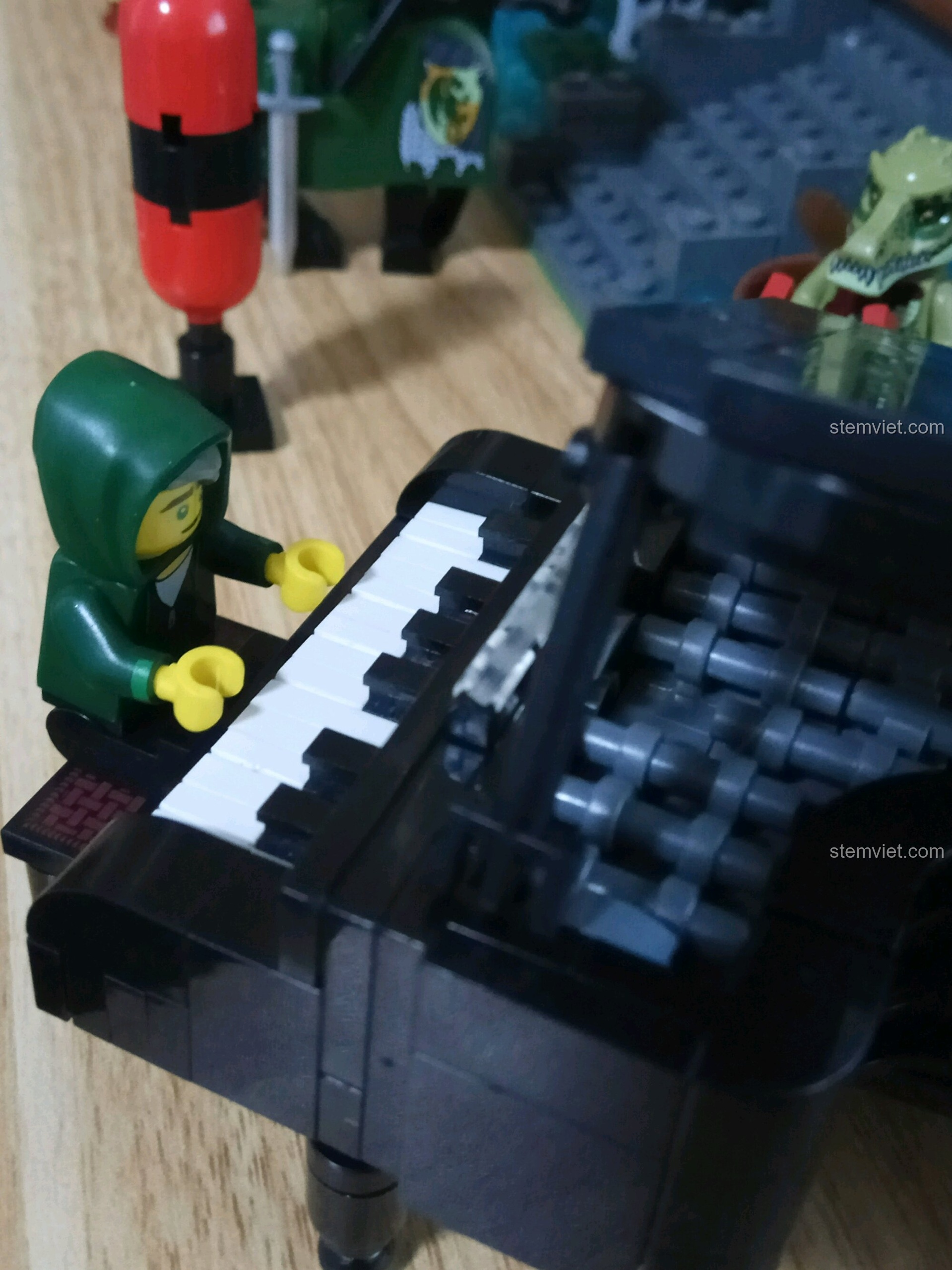 Cận cảnh bàn phím của Đàn Dương Cầm Cổ Điển QMAN 411 và minifigure đang chơi, làm nổi bật chi tiết và tính chân thực của mô hình.