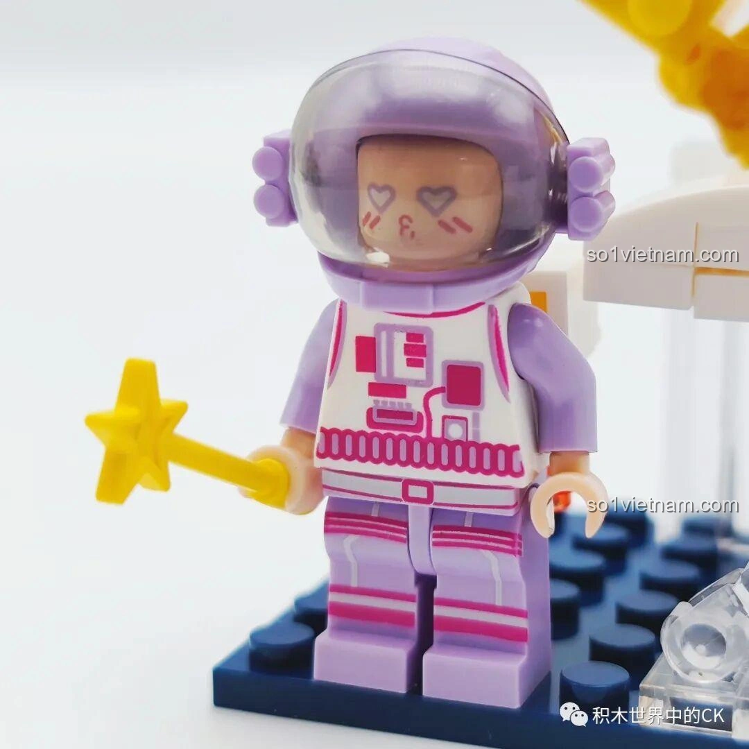 Cận cảnh phi hành gia tím của bộ đồ chơi WISE BLOCK HA390213, với biểu cảm đáng yêu, đôi mắt hình trái tim và bộ đồ phi hành gia màu tím pastel.