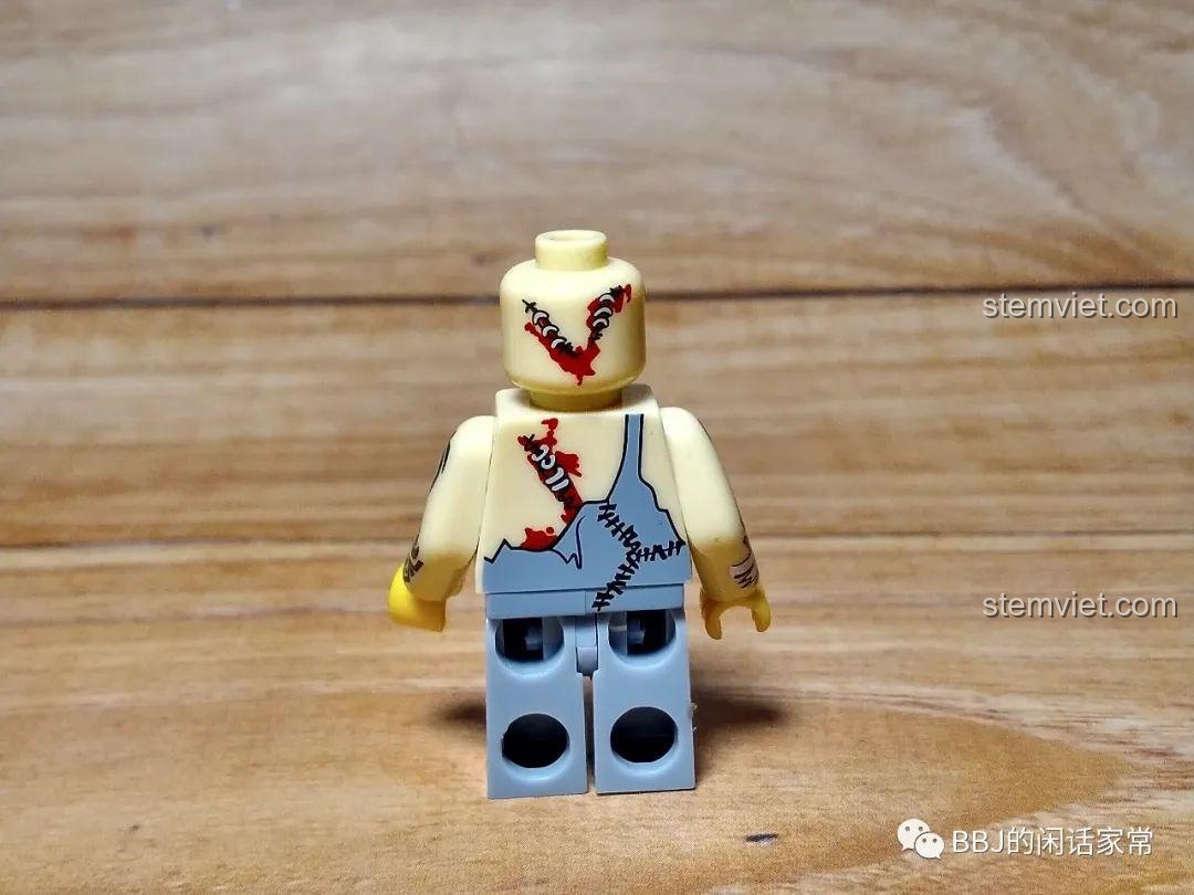 Mặt sau của minifigure Iron KY313, cho thấy các vết thương và chi tiết in sau lưng.