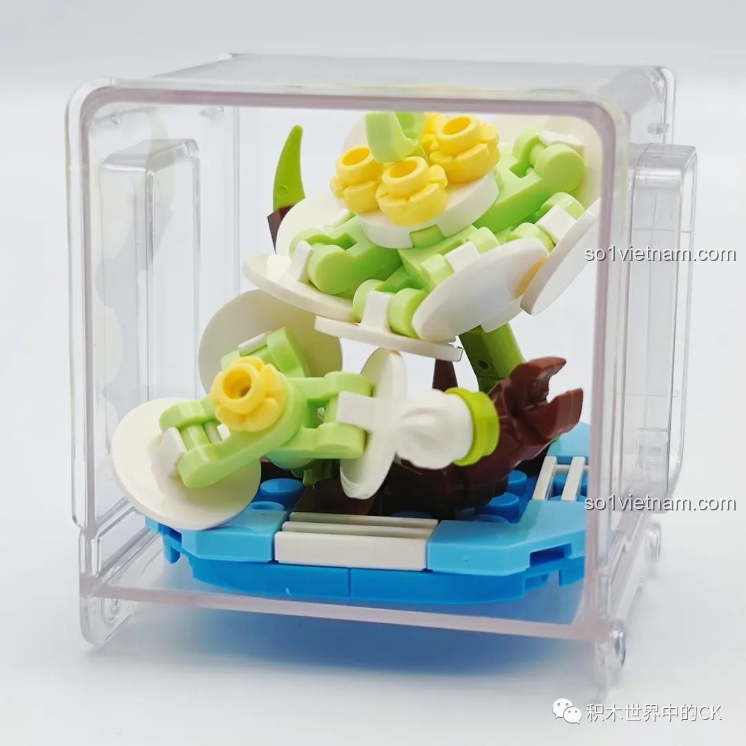 Mô hình chậu hoa trắng tinh khôi đã lắp ráp xong, đặt trong hộp trưng bày trong suốt của bộ AULDEY.