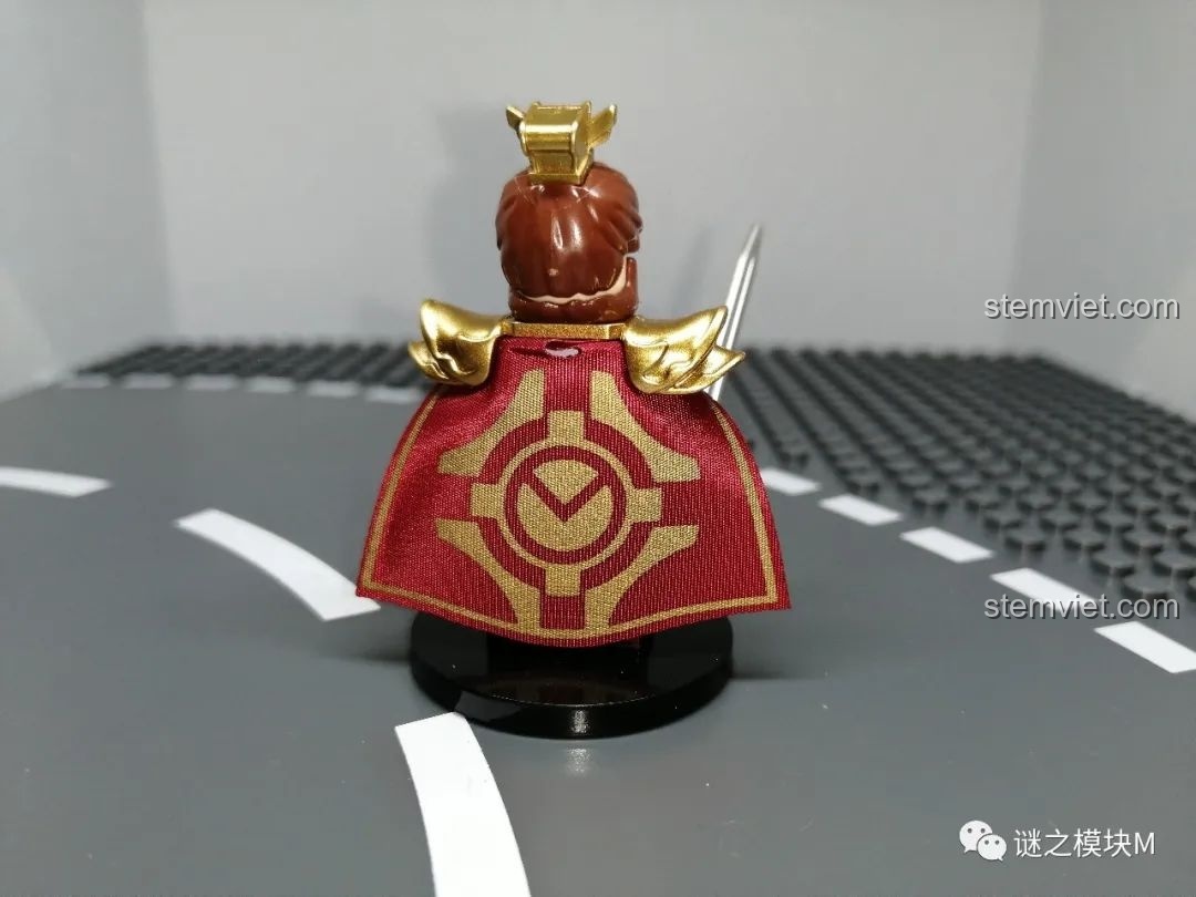 Mặt sau của minifigure Tôn Quyền, nổi bật với áo choàng đỏ có họa tiết vòng tròn vàng và giáp vai vàng.
