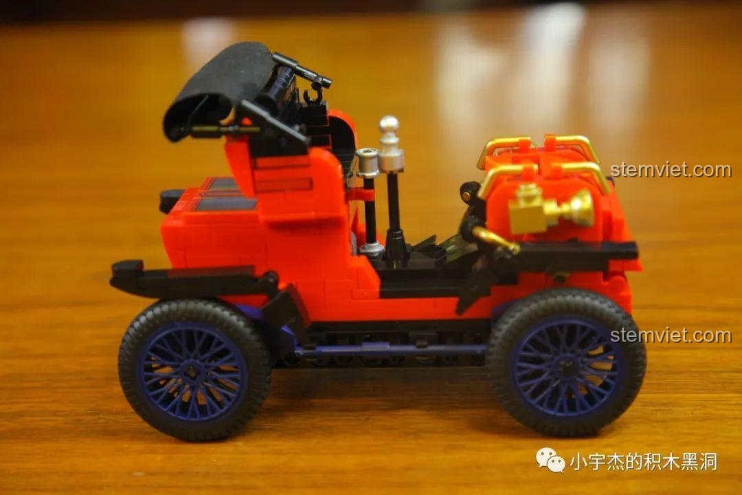 Mô hình xe Duryea Model L SEMBO 705400 nhìn từ bên hông, cho thấy chi tiết cần điều khiển và thân xe.