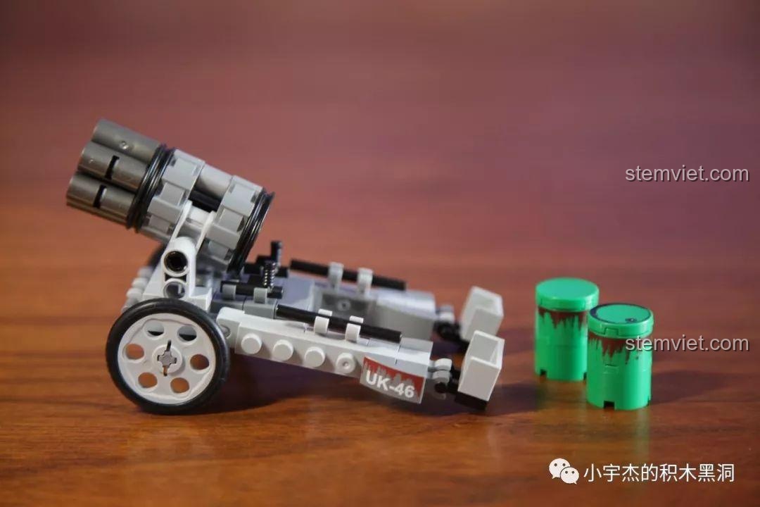 Cận cảnh mô hình Pháo phản lực SEMBO 101106 và hai thùng phuy, cho thấy chi tiết thiết kế của khẩu pháo.