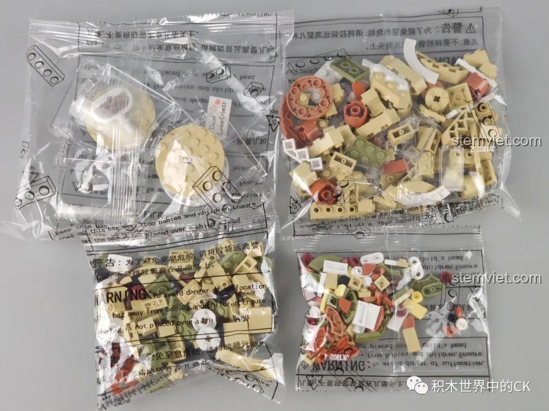 Hai mô hình Hộp nhạc thịt bò viên JAKI JK1801 và Hộp nhạc trà sữa JAKI đứng cạnh nhau, tạo thành bộ sưu tập ẩm thực.