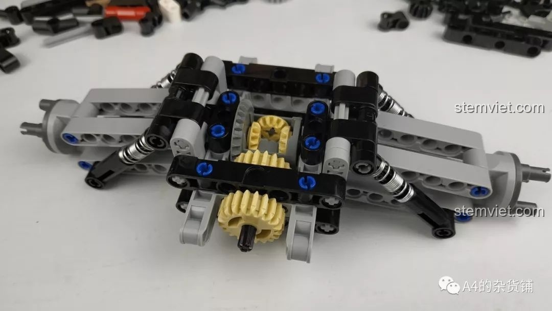 Cụm vi sai và hệ thống treo sau của mô hình CaDA C61016 với lò xo giảm xóc kim loại.