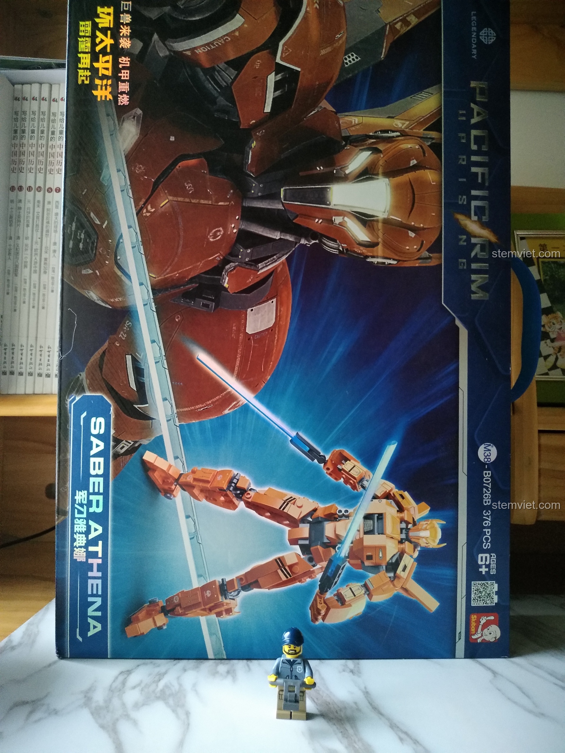 Mặt trước hộp bộ lắp ráp Robot Pacific Rim Saber Athena cho trẻ em 6+ với hình ảnh robot màu cam đang chiến đấu cực ngầu.