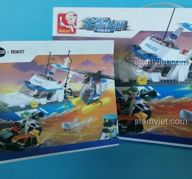 Hộp và sách hướng dẫn của bộ lắp ráp Sluban M38-B0657 Đội Cảnh Sát Tuần Tra Biển với hình ảnh tàu cảnh sát và trực thăng.