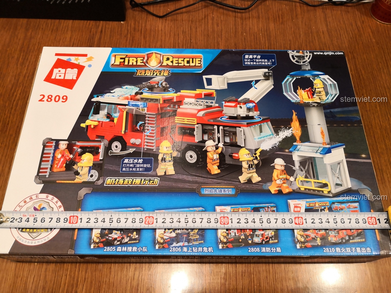 Hộp đồ chơi QMAN 2809 Xe Cứu Hỏa Sân Bay Tiên Phong với kích thước lớn, hình ảnh xe cứu hỏa và lính cứu hỏa sống động.