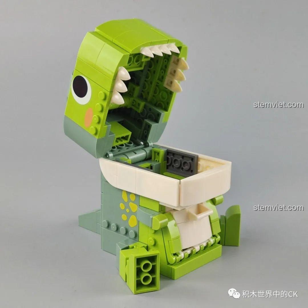 Mô hình hộp đựng đồ khủng long T-Rex JAKI Fun Desk với miệng mở rộng, để lộ không gian chứa đồ bên trong.