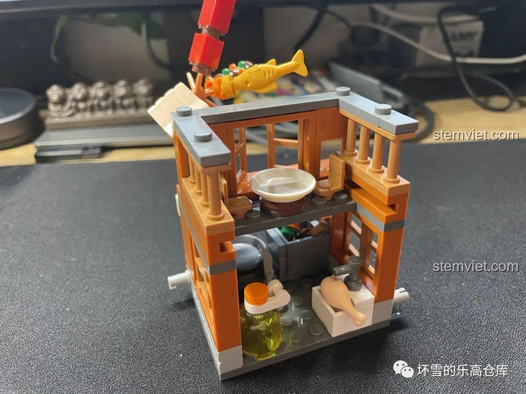 Nội thất bên trong Tiệm Đồ Chiên Văn Miếu Ký JAKI JK2131, có chậu rửa gà, thùng dầu và chảo chiên, tái hiện không gian bếp.