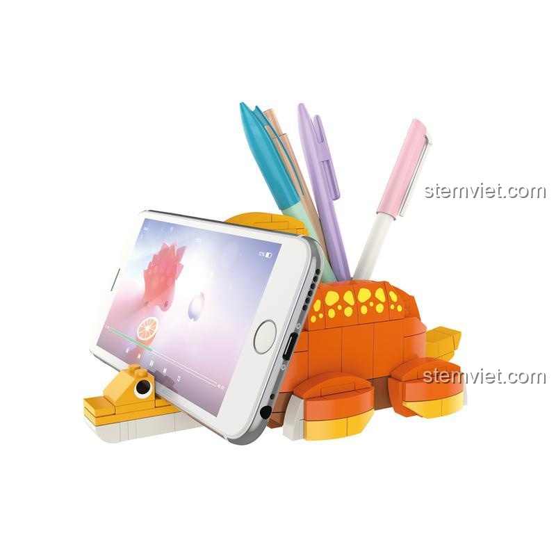 Đồ chơi lắp ghép JAKI JK5106 Khủng long Brachiosaurus đa năng, vừa là giá đỡ điện thoại vừa là hộp bút, màu cam vàng, cho bé 8 tuổi.