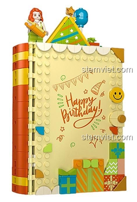 Mô hình sách đóng của bộ lắp ráp JAKI JK5150 Tiệc Sinh Nhật Sáng Tạo với dòng chữ 'Happy Birthday!' và các hộp quà, món quà tiết kiệm cho bé gái 8 tuổi.