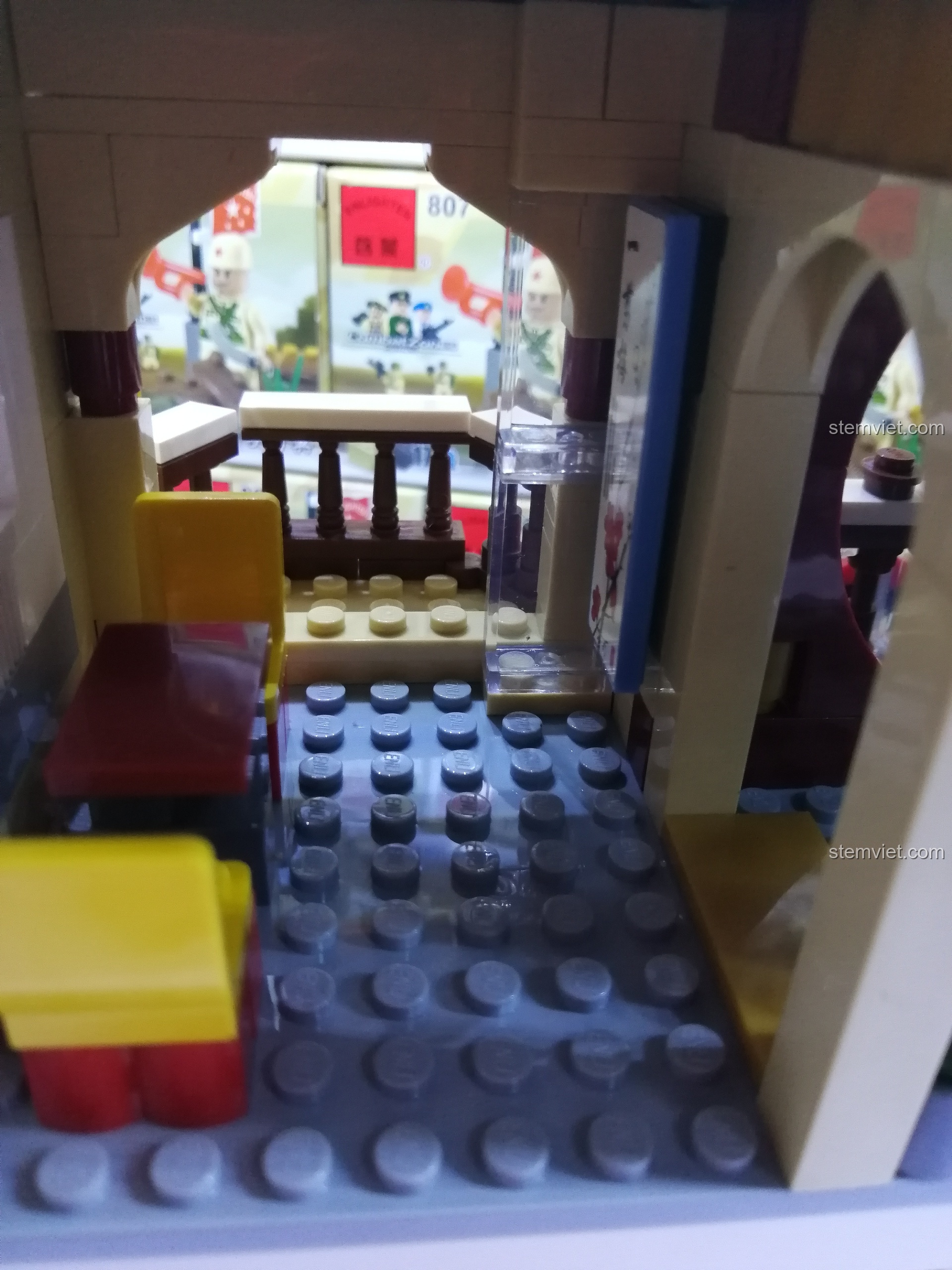 Không gian tầng hai của nhà hàng QMAN 1137 với bàn ghế và lan can, tạo cảm giác ấm cúng, riêng tư.