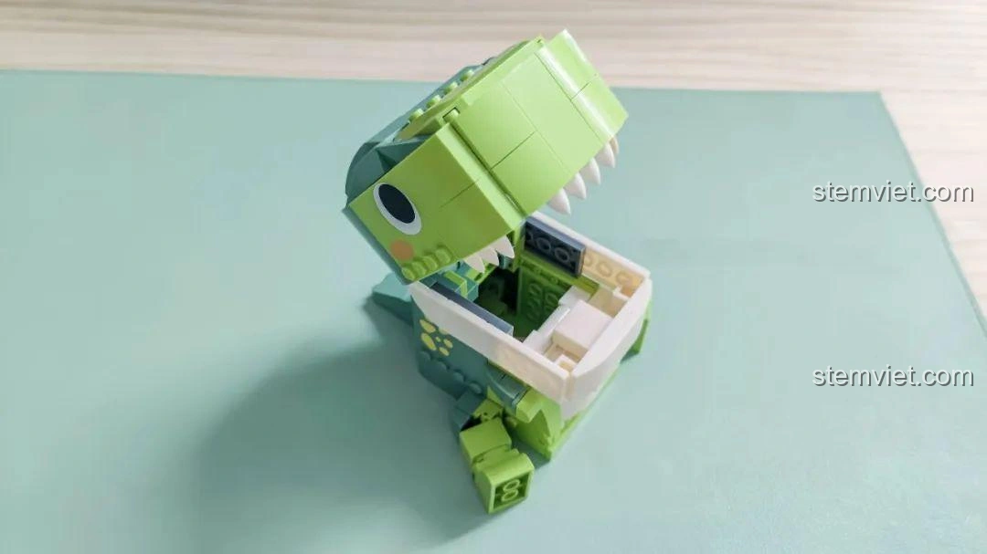 Khủng long T-Rex trong bộ JAKI JK5102 mở miệng, sẵn sàng 'ăn' đồ dùng học tập, thể hiện chức năng hộp đựng.