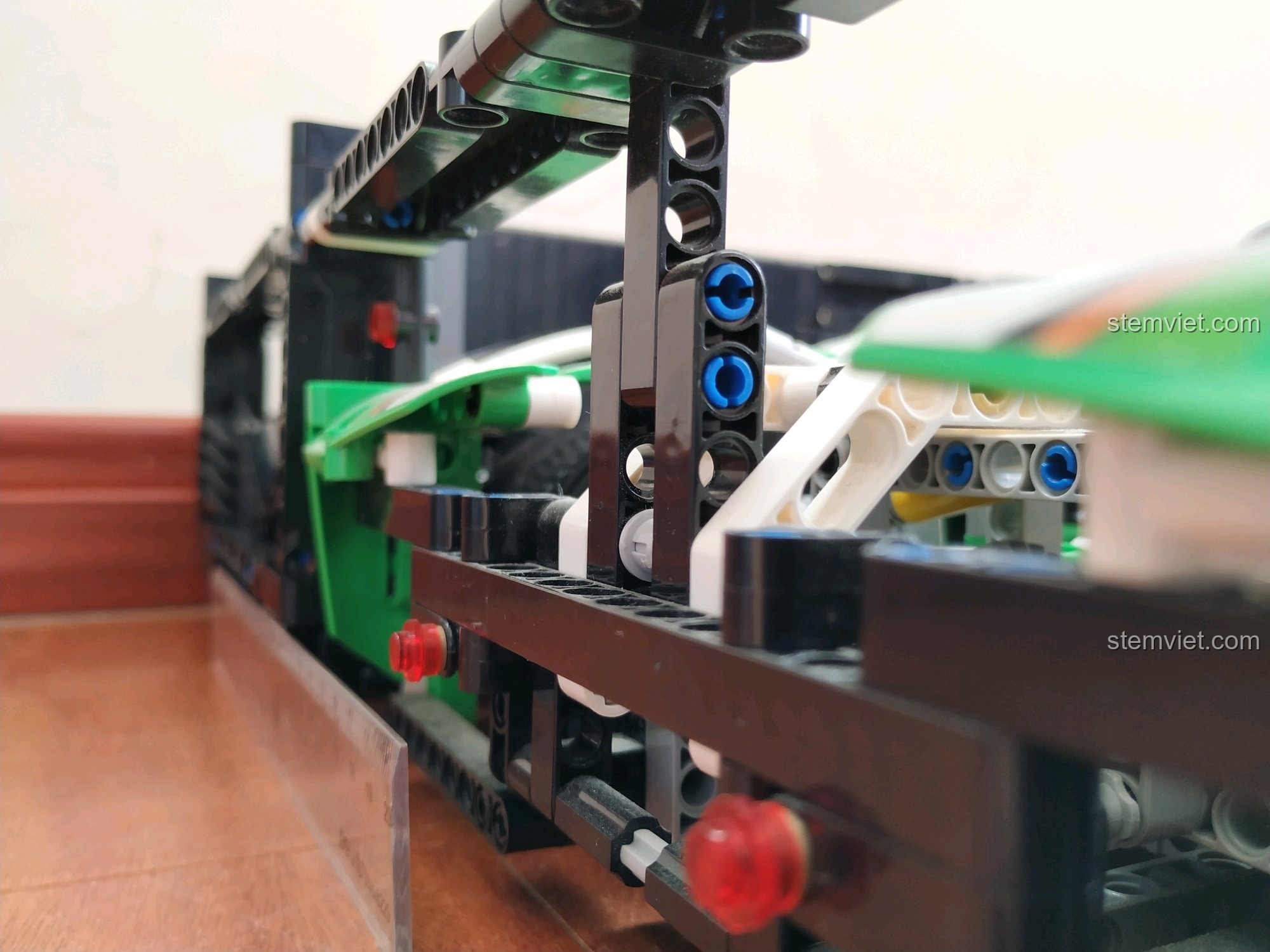 Cận cảnh chi tiết khớp nối và khung sườn của xe đua Porsche 919 Hybrid, thể hiện sự phức tạp trong thiết kế.