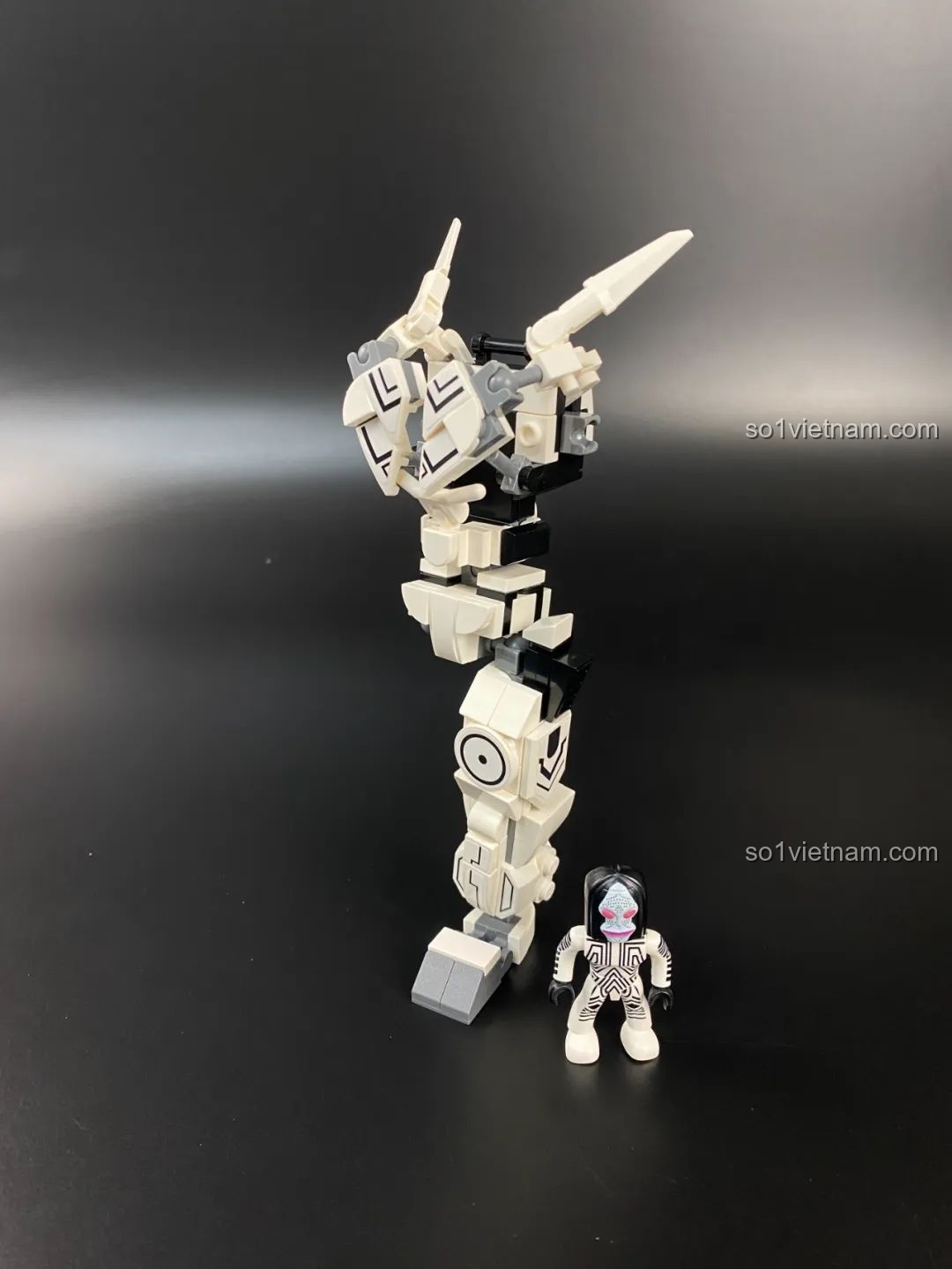 Quá trình lắp ráp phần chân của Mecha Dada, đứng cạnh minifigure để so sánh kích thước.