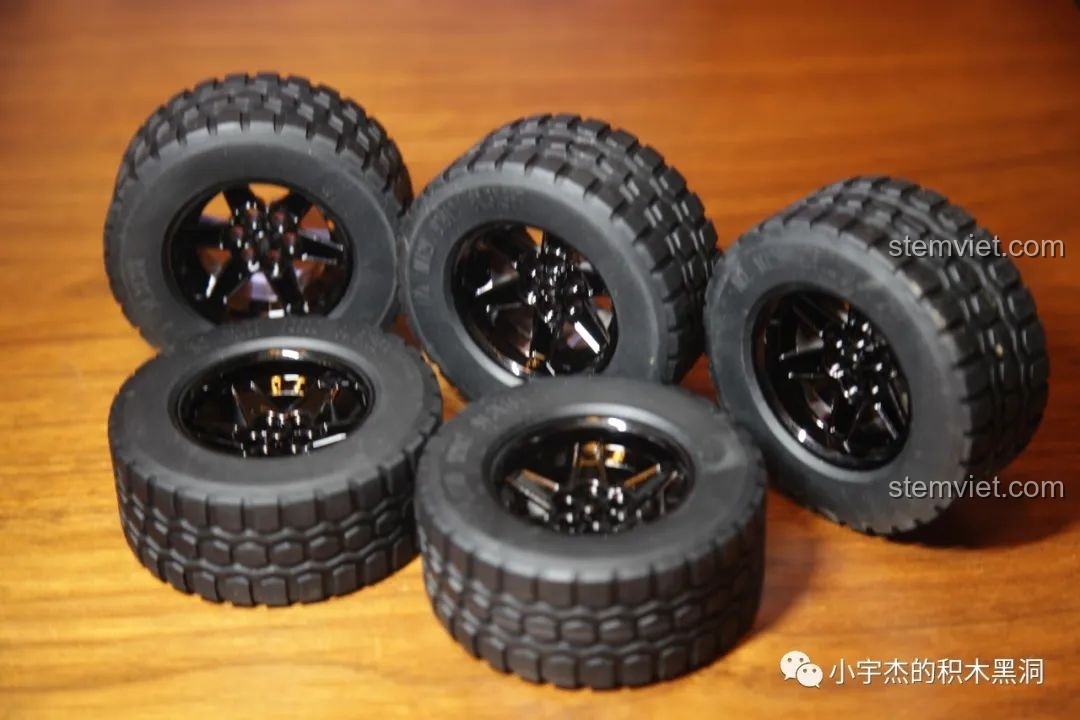 Năm chiếc lốp cao su với vân địa hình hầm hố được lắp vào vành xe, sẵn sàng cho mô hình Jeep.