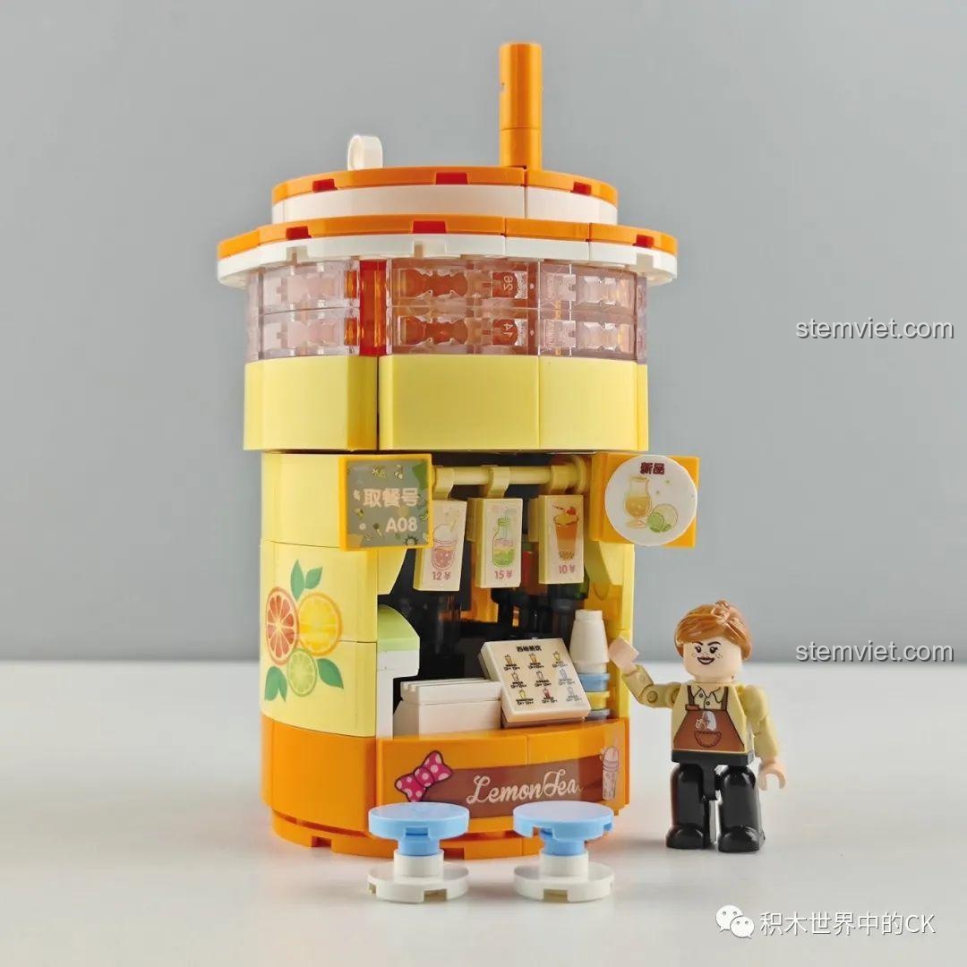Mô hình Cửa hàng Trà Sữa Zhe Gao CW6004 đã hoàn thành, thiết kế hình ly trà sữa độc đáo, màu vàng cam nổi bật.