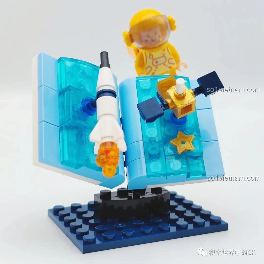 Mô hình Phi hành gia vàng Universe in a Book đã hoàn thành, với phi hành gia màu vàng, cuốn sách mở ra chứa tên lửa và vệ tinh, thuộc bộ đồ chơi WISE BLOCK HA390213.