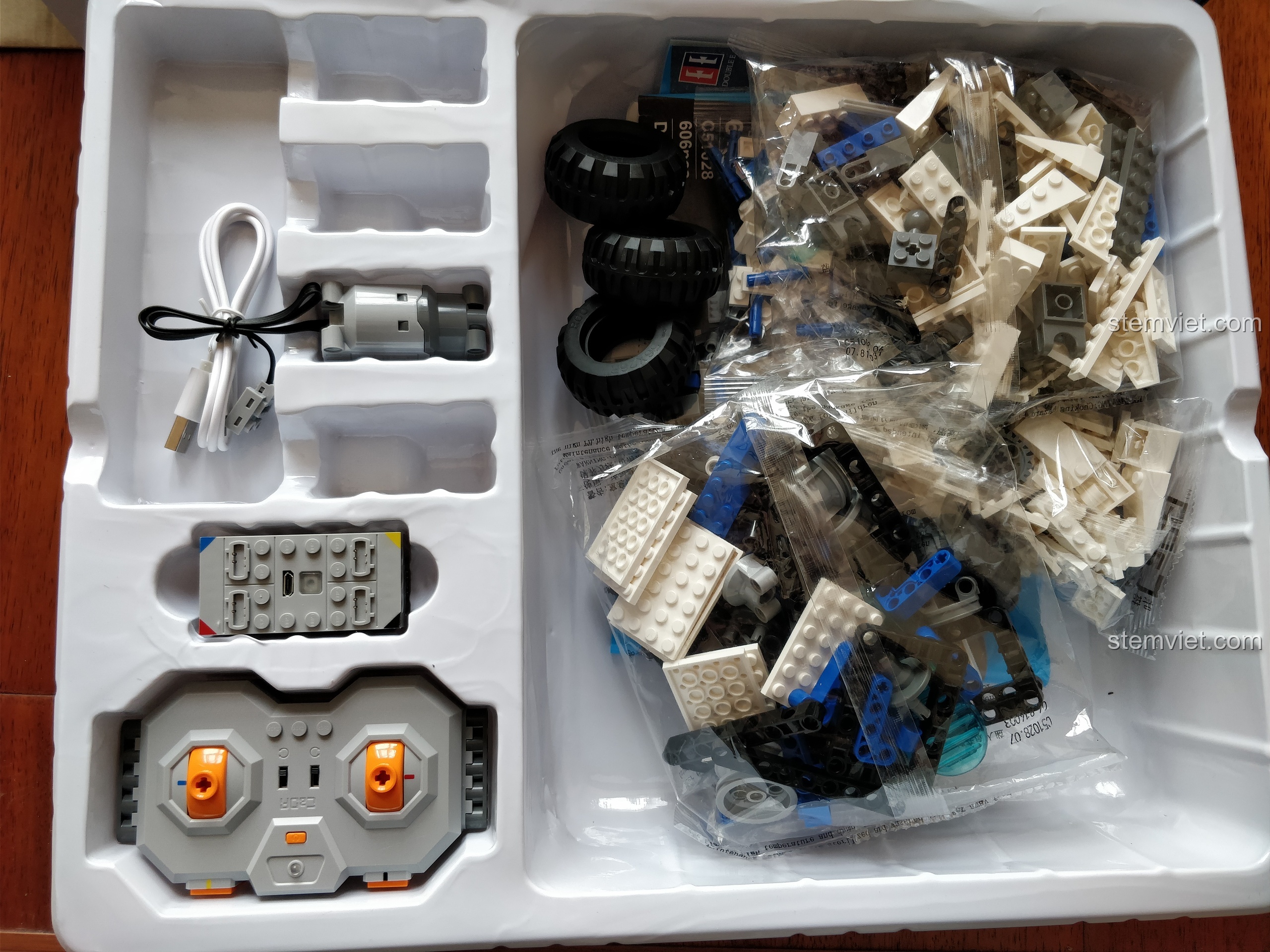 Bên trong hộp CaDA C51028 là khay nhựa chứa các túi chi tiết, động cơ, điều khiển và pin sạc.