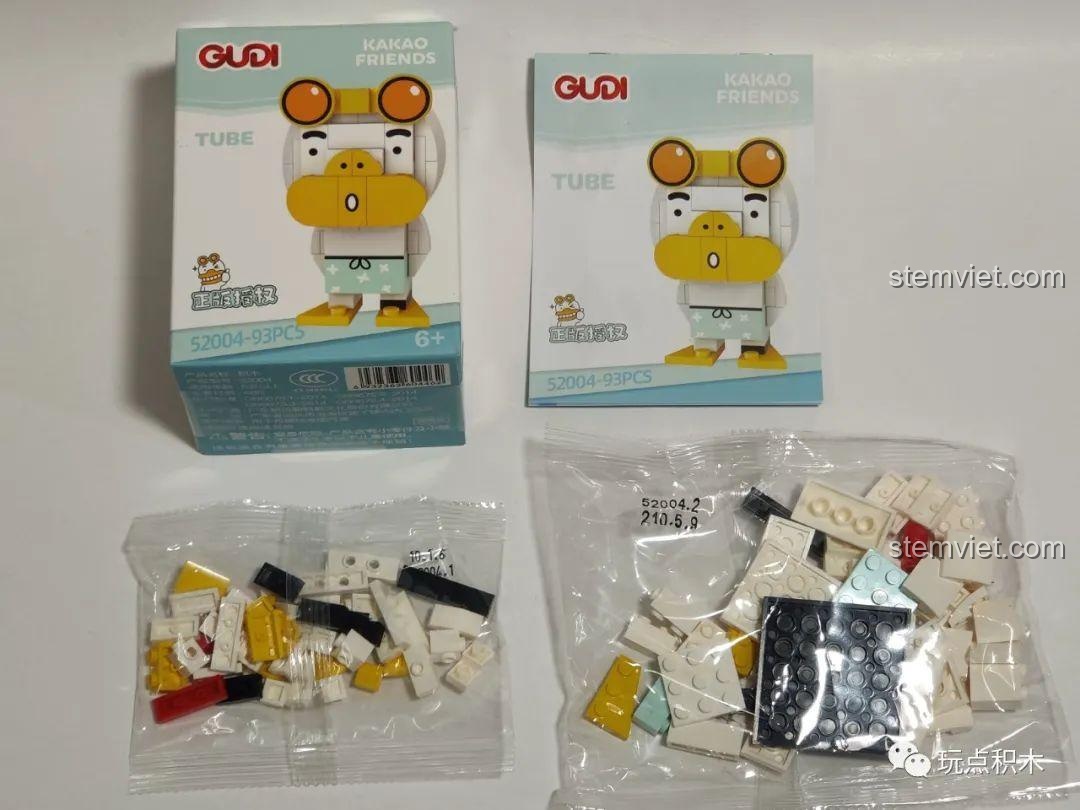 Mở hộp bộ lắp ghép GUDI 52004 Tube Kakao Friends, gồm sách hướng dẫn và các túi mảnh ghép.
