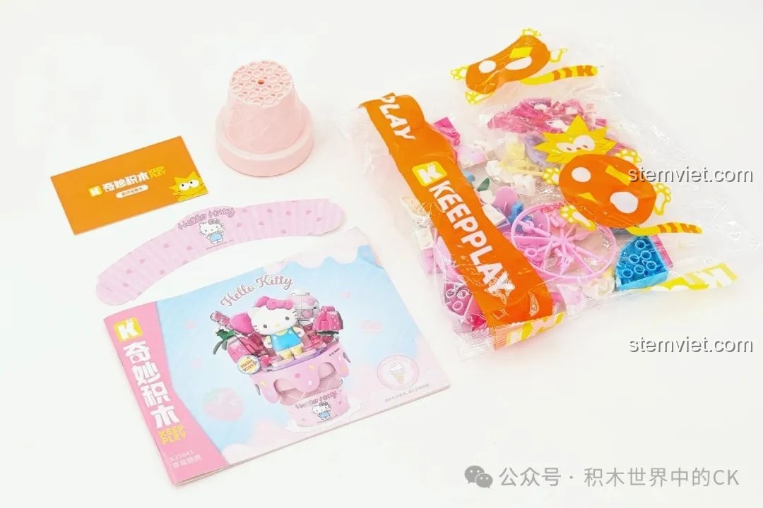 Bên trong hộp Keeppley K20841 Hello Kitty, bao gồm túi mảnh ghép, sách hướng dẫn, đế kem và sticker dán.