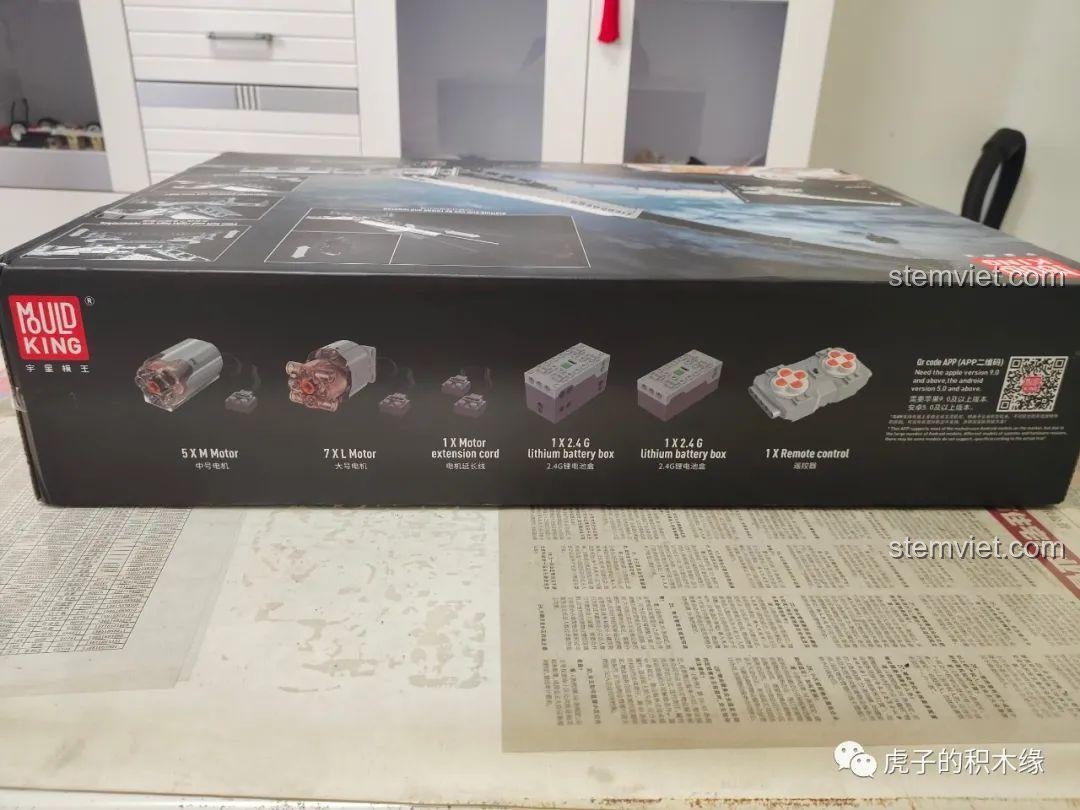 Mặt bên hộp bộ đồ chơi Mould King 17002, hiển thị các động cơ M và L, hộp pin và điều khiển từ xa, nhấn mạnh tính năng điện tử của cần cẩu Liebherr.