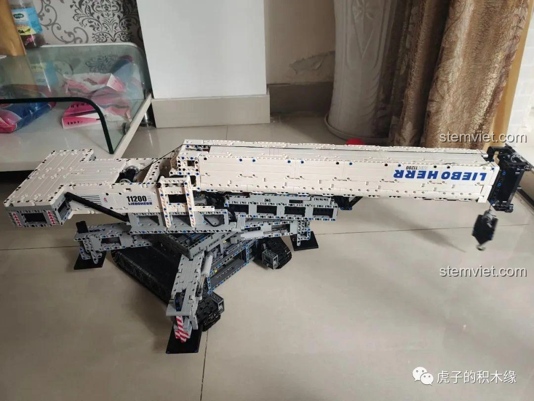 Toàn cảnh mô hình cần cẩu bánh xích Mould King 17002 Liebherr LTR 11200 đặt nằm ngang, thể hiện rõ kích thước và cấu trúc tổng thể.