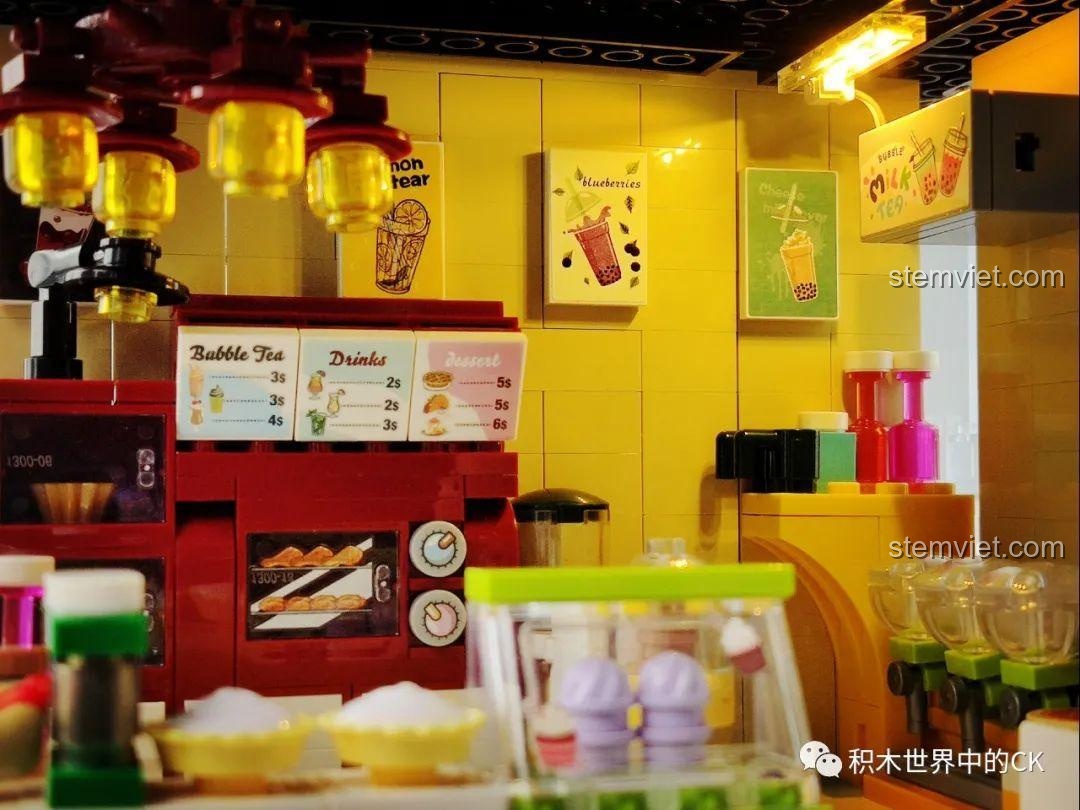 Cận cảnh ngăn kéo tủ trưng bày trong mô hình Cửa hàng trà sữa JIAZHI SY 5209, với thìa và dụng cụ.