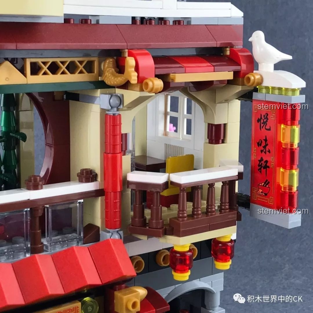 Chi tiết ban công trên tầng hai của nhà hàng QMAN 1137 với lan can, đèn lồng và biển hiệu dọc rất đẹp.