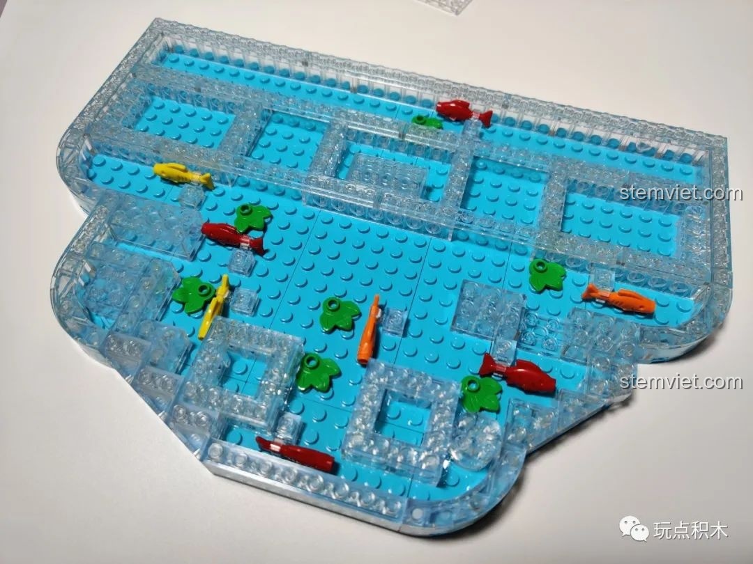 Các mảnh ghép trong suốt được thêm vào đế nước của bộ Cá Chép Hóa Rồng Pantasy 18001, tạo hiệu ứng chiều sâu.