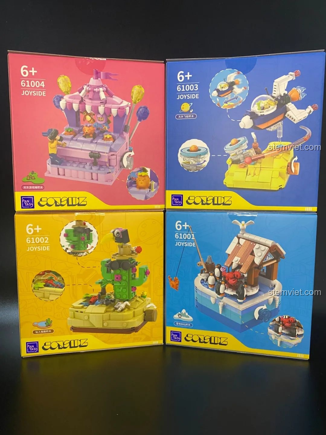 Mặt sau của bốn hộp đồ chơi lắp ráp Pantasy Joyside 61001, 61002, 61003, 61004, hiển thị hình ảnh mô hình hoàn chỉnh và các tính năng tương tác.